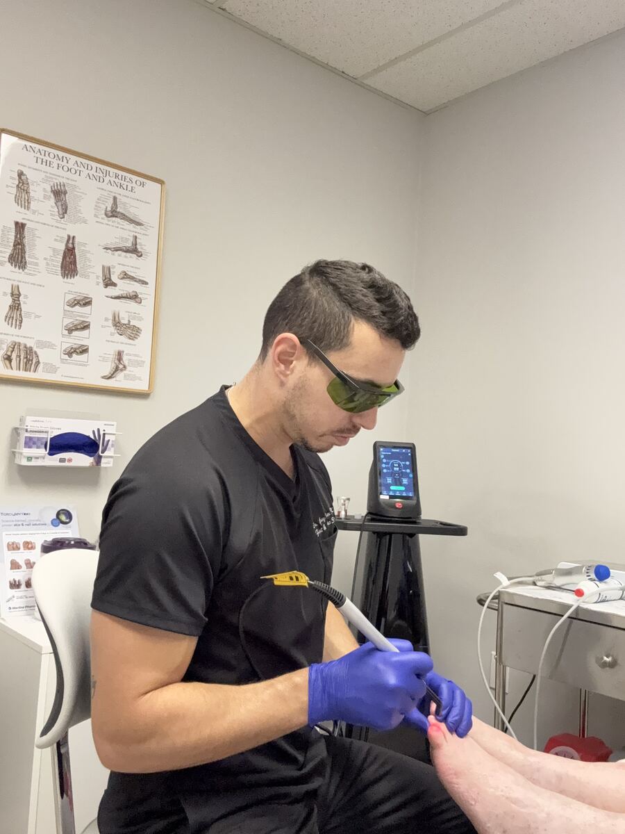 Dr. Golan performing Remy laser treatment - Vertex Podiatry Columbus OH