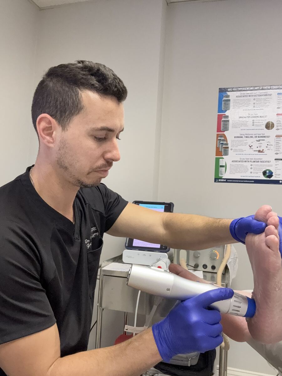 Dr. Golan performing shockwave therapy - Vertex Podiatry Columbus OH